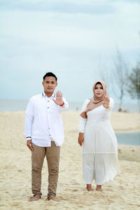 Portrait of young couple standing on land