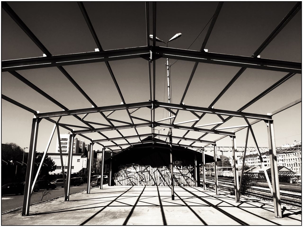 built structure, architecture, transportation, metal, bridge - man made structure, connection, sky, clear sky, incidental people, low angle view, sunlight, the way forward, day, auto post production filter, metallic, transfer print, railing, shadow, tree, engineering