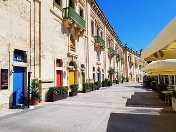 Street amidst buildings against sky