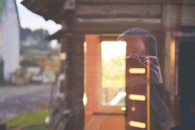 Close-up of man driving car against blurred background