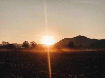 Scenic view of field against sky during sunset