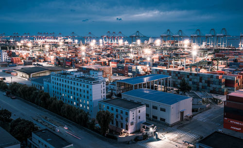 High angle view of illuminated buildings against sky at dusk