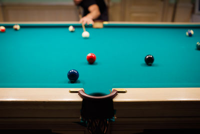 Midsection of man playing pool