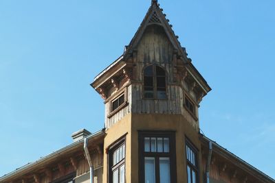 Low angle view of building against clear blue sky