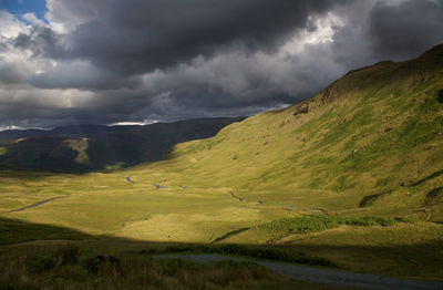 Scenic view of mountains against cloudy sky