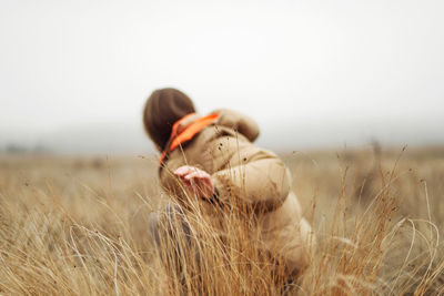 Unrecognizable female hands in autumn grass