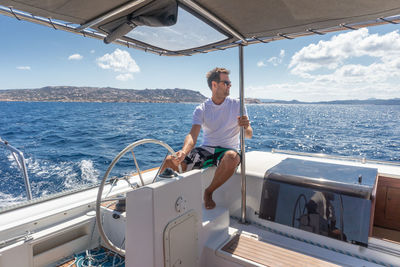 Man looking away sitting on boat