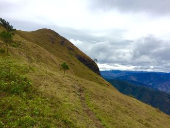 Scenic view of landscape against cloudy sky