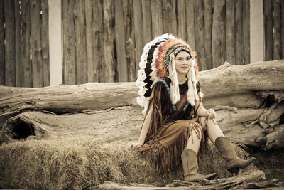 Portrait of a woman sitting on wood