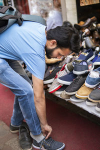 Man trying shoes in market