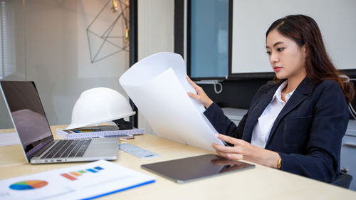 Portrait of businesswoman working on table