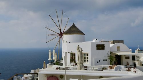 Traditional windmill by sea against sky. beautiful greek scenery 