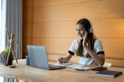 Businesswoman using laptop at office