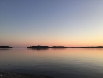 Scenic view of sea against clear sky during sunset