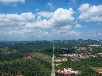 Aerial view of houses on landscape against sky