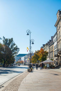 Street amidst buildings against clear sky