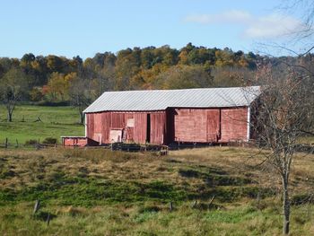 Abandoned house on field against sky