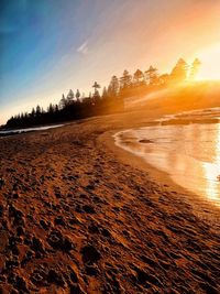 Scenic view of beach against sky during sunset