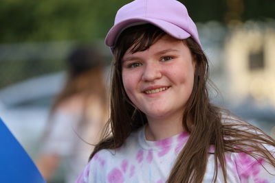 Portrait of smiling teenage girl wearing cap