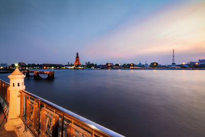 View of illuminated built structures at sunset