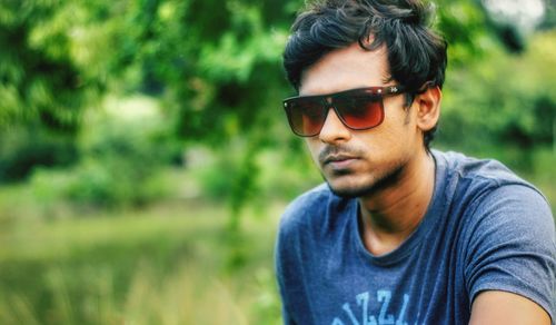 Young man wearing sunglasses on field