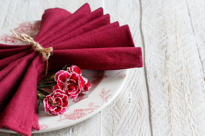 High angle view of red roses in plate on table