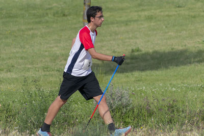 Side view of man playing on field