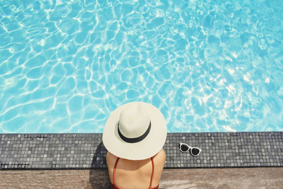 High angle view of woman by swimming pool