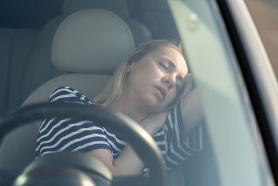 Portrait of woman sitting in car