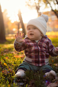 Little cute baby boy have fun outdoors in the park in autumn time