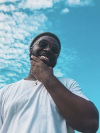 Portrait of young man against blue sky