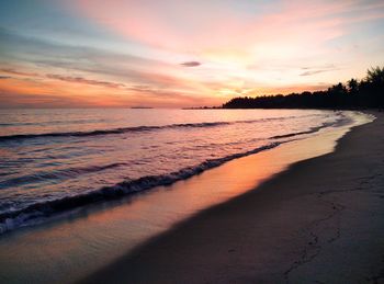 Scenic view of beach against sky during sunset