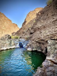 Scenic view of river amidst rock formation against sky
