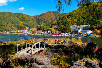 Group of people on bridge over lake