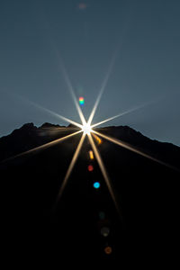 Low angle view of illuminated lights against clear sky at night