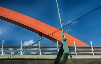 Low angle view of bridge against blue sky