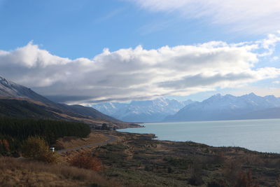 Scenic view of sea and mountains against sky