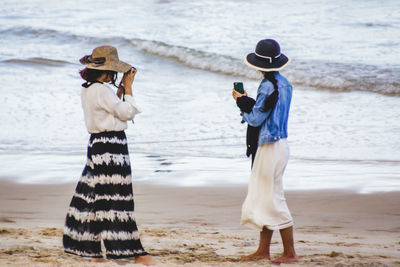 Friends photographing at beach