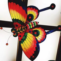 Low angle view of multi colored balloons hanging against clear sky