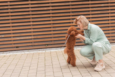 Woman with dog sitting outdoors