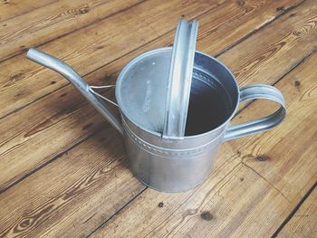 Close-up of watering can on table