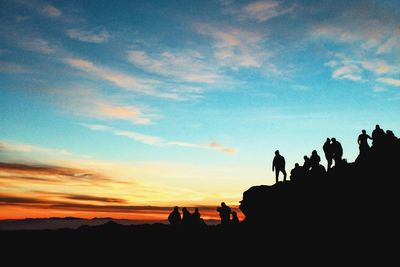 Low angle view of silhouette people against sky during sunset