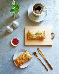 Chicken pie puff pastry and a cup of coffee on the table