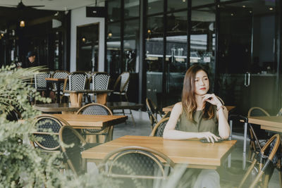 Young woman sitting on table
