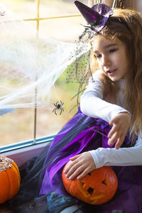 Portrait of young woman with pumpkin