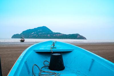 Ship in sea against clear blue sky