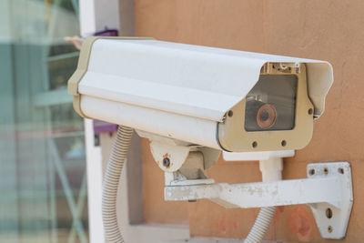 Close-up of telephone booth against wall at home