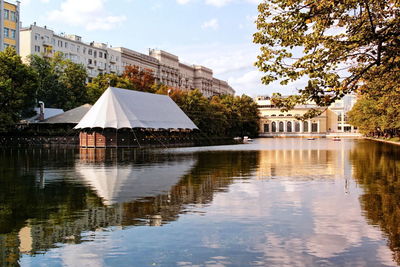 Reflection of built structure in water against sky