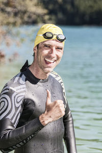 Portrait of a smiling young man swimming in pool