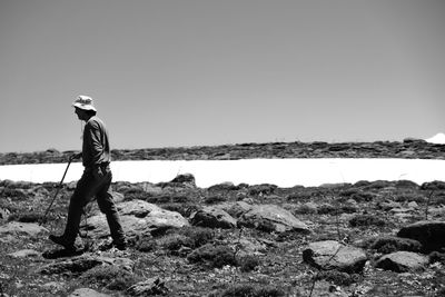 Man standing on field against clear sky